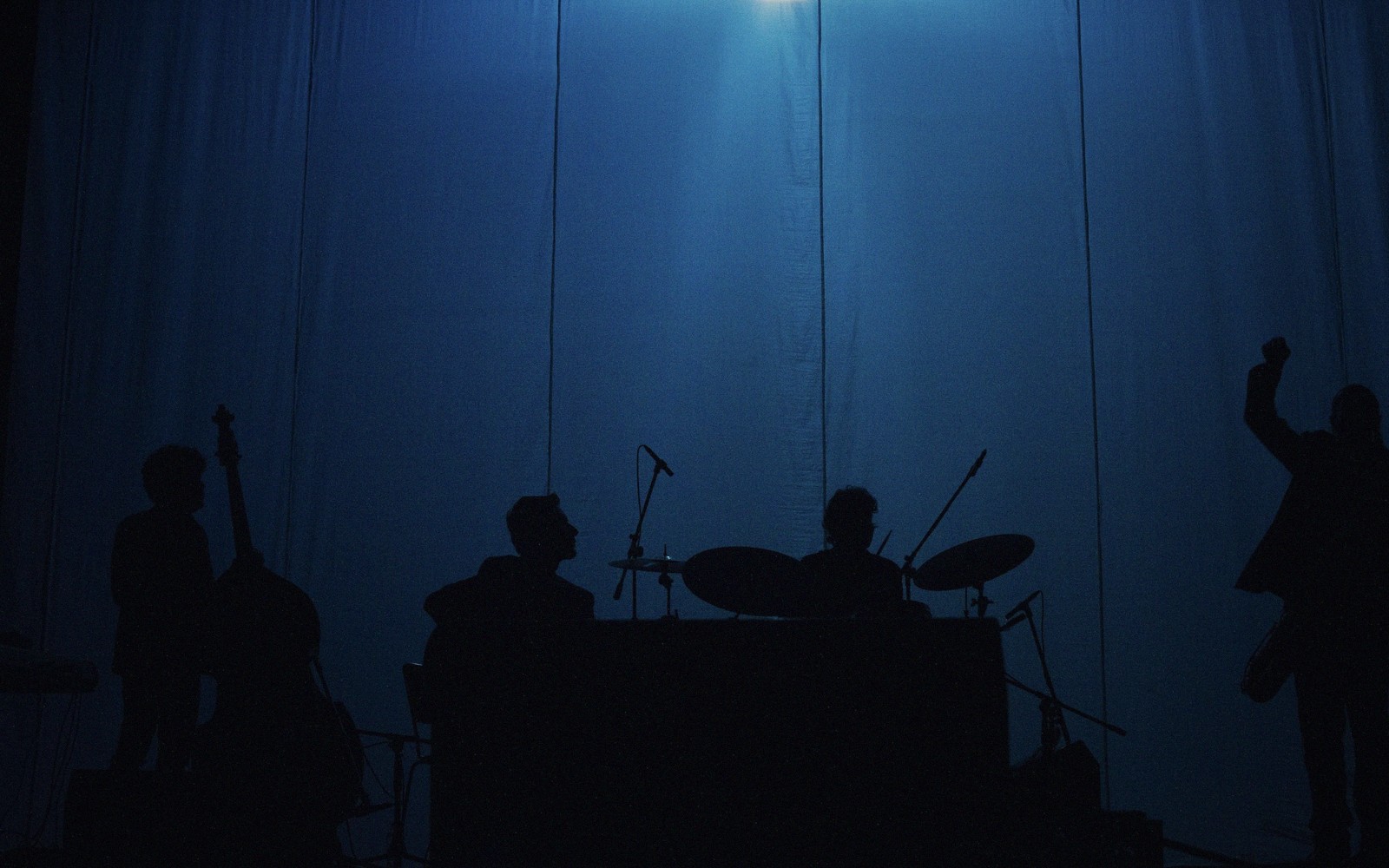 A jazz cellar stage set with drums and a microphone before a set